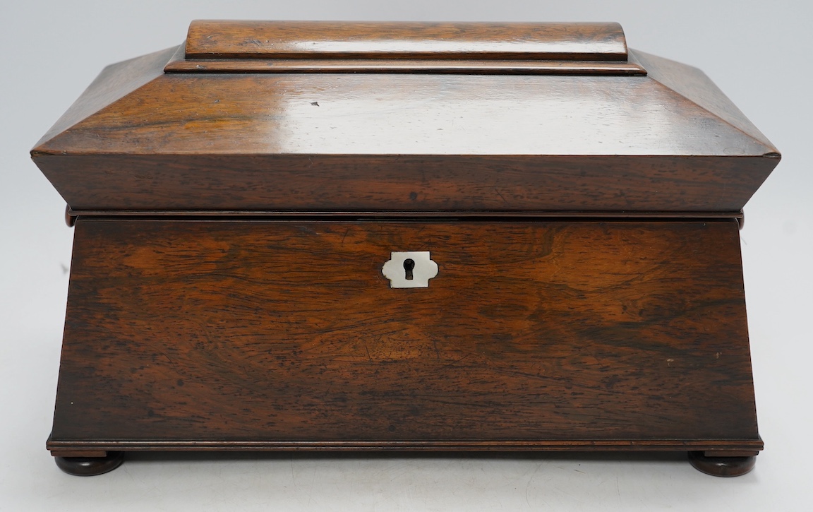 A Victorian rosewood sarcophagus shaped tea caddy with mother of pearl escutcheon, 33.5cm wide. Condition - fair, some internal damage